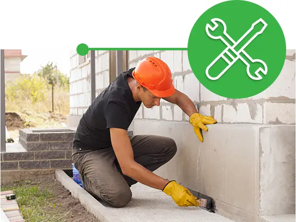 man repairing a cracked foundation
